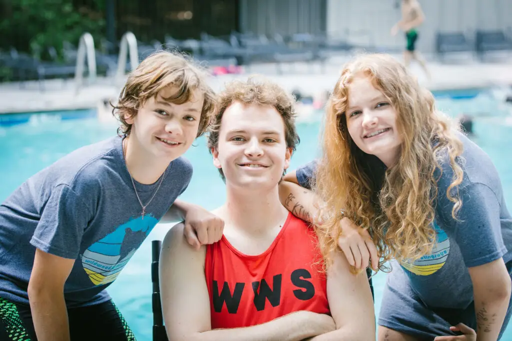 Coach Veronica Janus three children who are competitive swimmers and coaches during a swim a meet