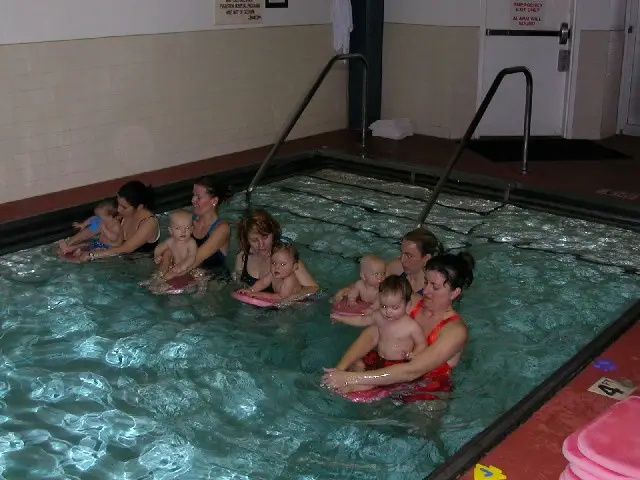 Parents and babies with their moms in swimming pool for a swim lesson