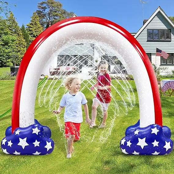 Kids and Adults having fun in an Independence Day Themed sprinkler arch in the backyard