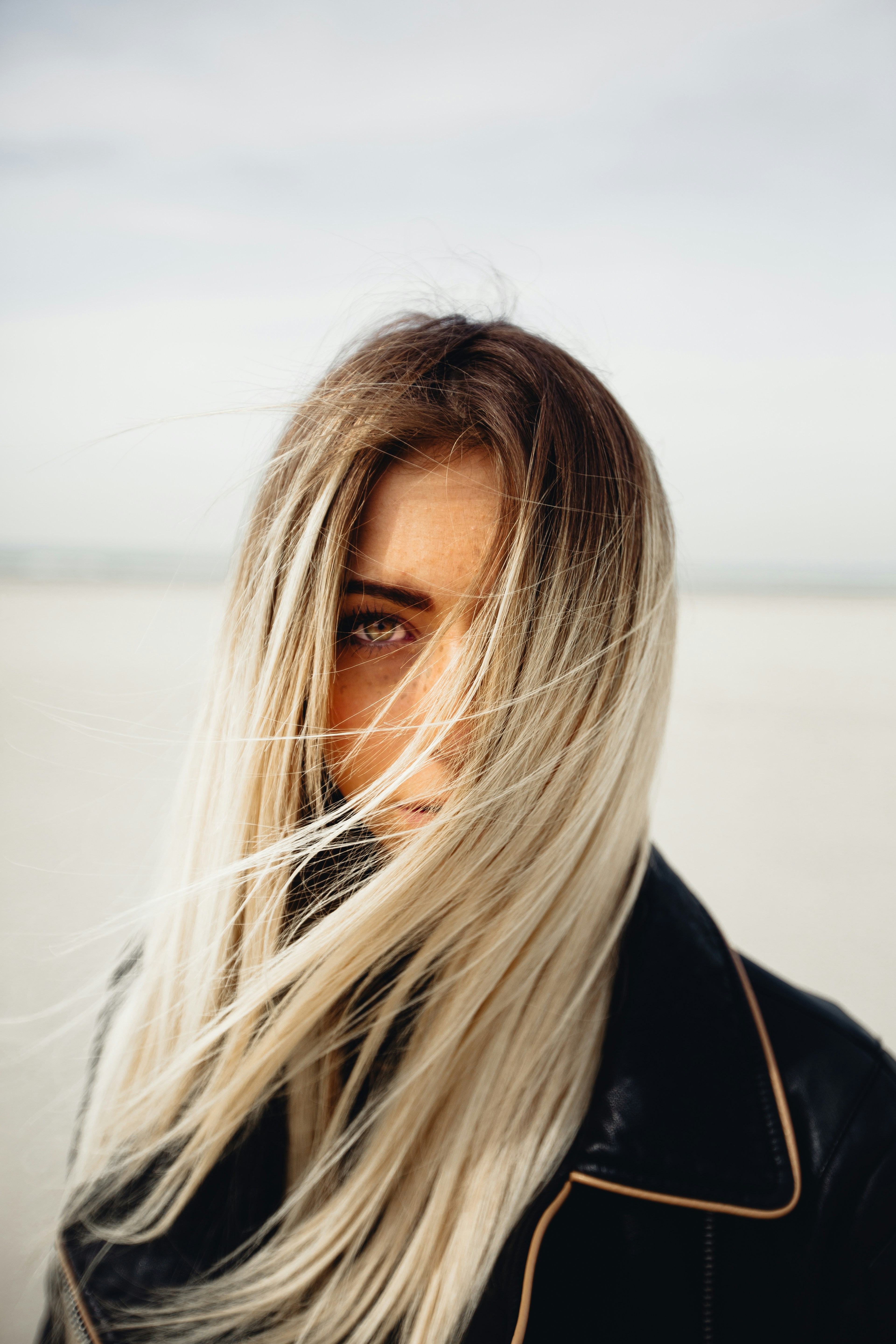 Beautiful long blonde highlights on woman standing outside in blowing wind