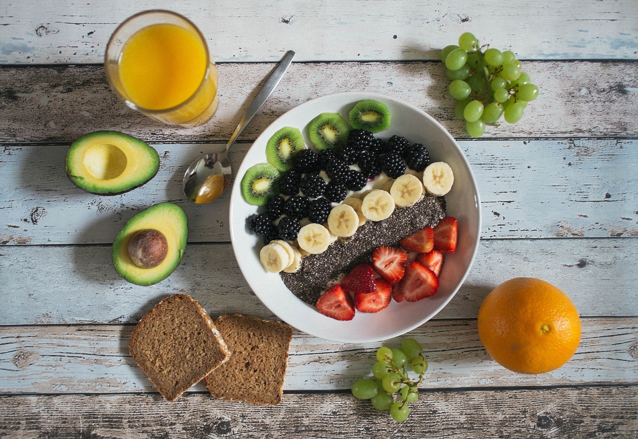 Healthy Breakfast foods for athletes and swimmers on a table filled with whole grains, fruits, vegetables