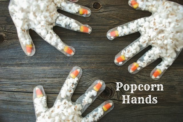 popcorn and candy placed in PPE gloves for cute Halloween treat